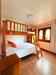 a bedroom with two bunk beds and a ladder at Hospedaje Vista Hermosa Salento in Salento