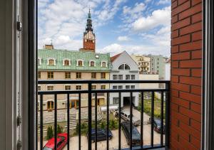 a view of a city from a window at CudNajem Old Town Apartments - Bulvar in Elblag