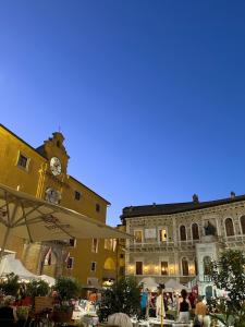 a building with a clock tower in a town square at B&B La Tenuta in Fermo