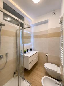a bathroom with a toilet and a sink and a shower at Seven Suite SPA in Fiumicino