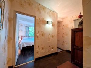 a bedroom with a mirror and a bed in a room at Le Charme in Eauze