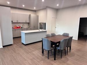 a kitchen and dining room with a table and chairs at Reddy Home in Lautoka