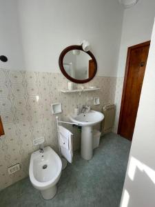 a bathroom with a sink and a toilet and a mirror at ca' de Nardo in Tuoro sul Trasimeno +6 photos