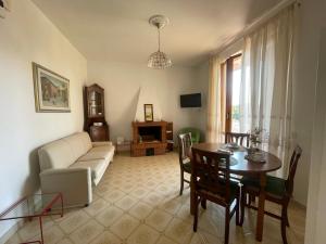 a living room with a table and a couch at ca' de Nardo in Tuoro sul Trasimeno