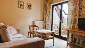 a living room with a couch and a table and a window at Villa Orlik in Barlinek