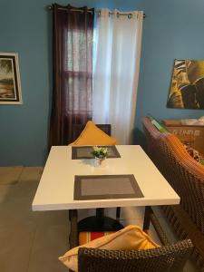 a white table with a bowl of flowers on it at Attres in Monkey Hill +5 photos
