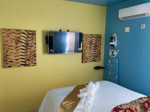 a bedroom with a bed and a tv on the wall at Attres in Monkey Hill