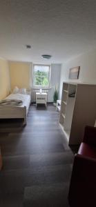 a large room with a bed and a window at Dehmkerhof in Aerzen +25 photos