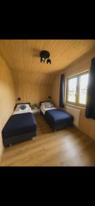 a room with two beds and a window in it at Domki Norda in Władysławowo