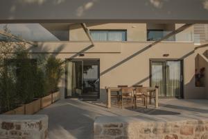 a patio with a table and chairs in front of a building at Casa di Mare in Kyparissia