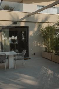 a patio with a table and chairs next to a building at Casa di Mare in Kyparissia