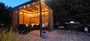 a gazebo with a table and chairs on a patio at Sosenka in Niechorze