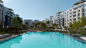 a large swimming pool in a city with buildings at SEACODE Hotel in El Alamein