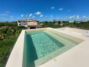 a swimming pool on the roof of a house at Private luxury villa in Holbox Island
