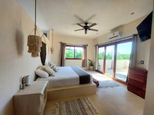 a bedroom with a bed and a ceiling fan at Private luxury villa in Holbox Island +59 photos