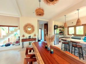 a large living room with a wooden table and a kitchen at Private luxury villa in Holbox Island