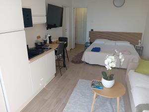 a room with a bed and a kitchen and a table at Vista Resort OPENING 13-7-26 in Albisola Superiore