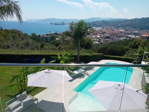 a villa with a pool and a view of the water at Vista Resort OPENING 13-7-26 in Albisola Superiore