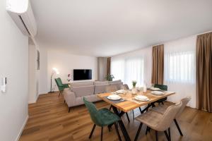 a living room with a table and a couch at Villa Rocco in Srima