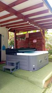 a pool table under awning in a yard at Maison cosy à Lamentin, 20m², climatisation in Lamentin