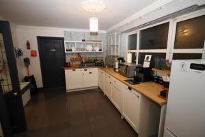 a kitchen with white cabinets and a counter top at Gra accommodations athy in Athy