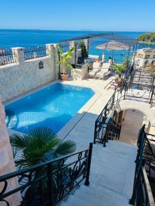 a swimming pool with a view of the ocean at The Poet's House in Himare