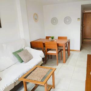 a living room with a table and a couch at MEDITERRÁNEO Benicarló NG in Benicarló