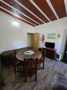 a living room with a table and chairs and a couch at La Chiquitita in Villa Dolores