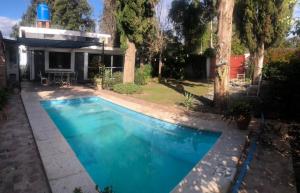 a swimming pool in the yard of a house at La Chiquitita in Villa Dolores