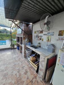 a kitchen with a counter with a fan on the wall at La Chiquitita in Villa Dolores
