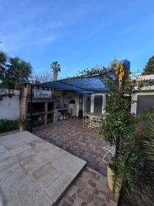 a house with a patio with a table and chairs at La Chiquitita in Villa Dolores