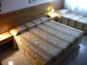 Postel nebo postele na pokoji v ubytování Hotel Sport
