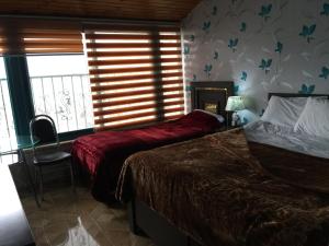 Voodi või voodid majutusasutuse Isra Hotel toas