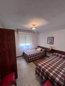 a bedroom with two beds and a window in it at Eclipse in Villasandino