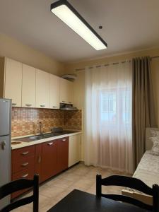 a kitchen with a sink and a counter top at Shengjin Central Apartments in Shëngjin