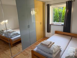 a bedroom with two beds and a mirror at Seaside Home in Fakse Ladeplads