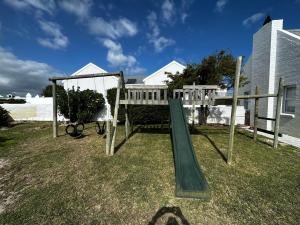 a playground with a slide in a yard at Happy Place in Grotto Bay