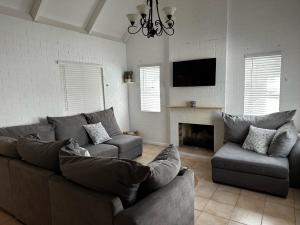 a living room with a couch and a fireplace at Happy Place in Grotto Bay