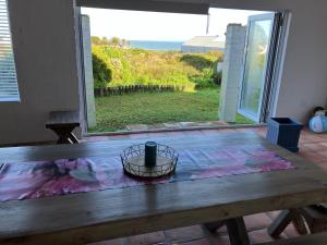 a wooden table with a vase on top of it at Happy Place in Grotto Bay
