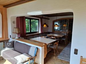 a kitchen and dining room with a table and chairs at Haus Mooswald in Lechleiten