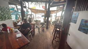 a couple of people sitting at tables in a restaurant at Pikua Beach Baru in Playa Blanca