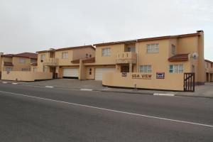 a row of apartment buildings on the side of a street at Monotoka Self Catering Apartments CC in Swakopmund