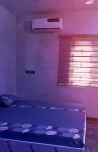 a bed in a room with a purple light at M & A Homes Ilorin in Ilorin