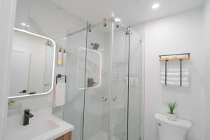 a bathroom with a glass shower and a toilet at Nox Hotel - Studio City in Studio City