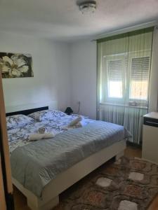a bedroom with a bed with two people laying on it at Apartment Dolic - Your peaceful spot with a panoramic view in Livno