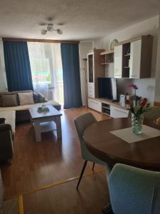 a living room with a couch and a table at Apartment Dolic - Your peaceful spot with a panoramic view in Livno