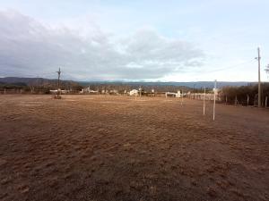 an empty field with some poles in the dirt at Cabaña LDM cc in Santa Rosa