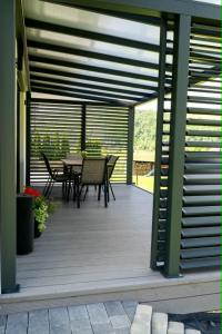 a wooden deck with a table and chairs on it at Domek pod Nowiną in Tylmanowa +16 photos