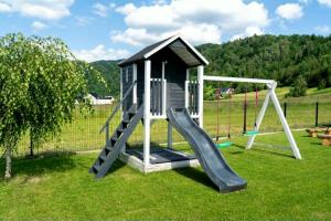 a playground with a slide in the grass at Domek pod Nowiną in Tylmanowa