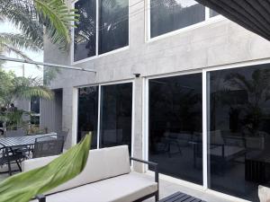 a house with sliding glass doors on a patio at Mais Residence in Bijilo